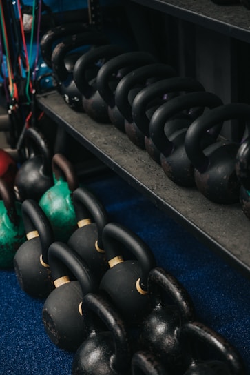 High-quality kettlebells arranged on a wooden floor with natural light highlighting their texture