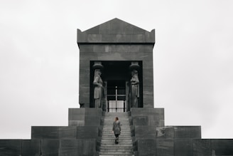 2 women standing in front of gray concrete building during daytime