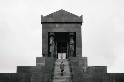 2 women standing in front of gray concrete building during daytime