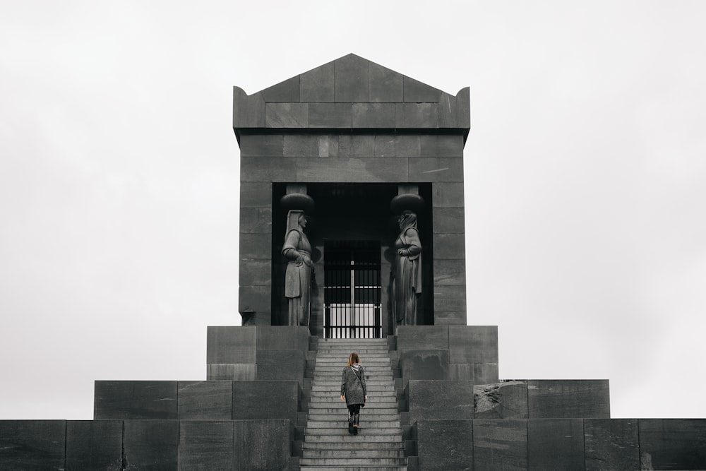 2 women standing in front of gray concrete building during daytime