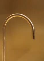 A sleek, modern bathroom with brushed gold fixtures reflecting findepot's premium design