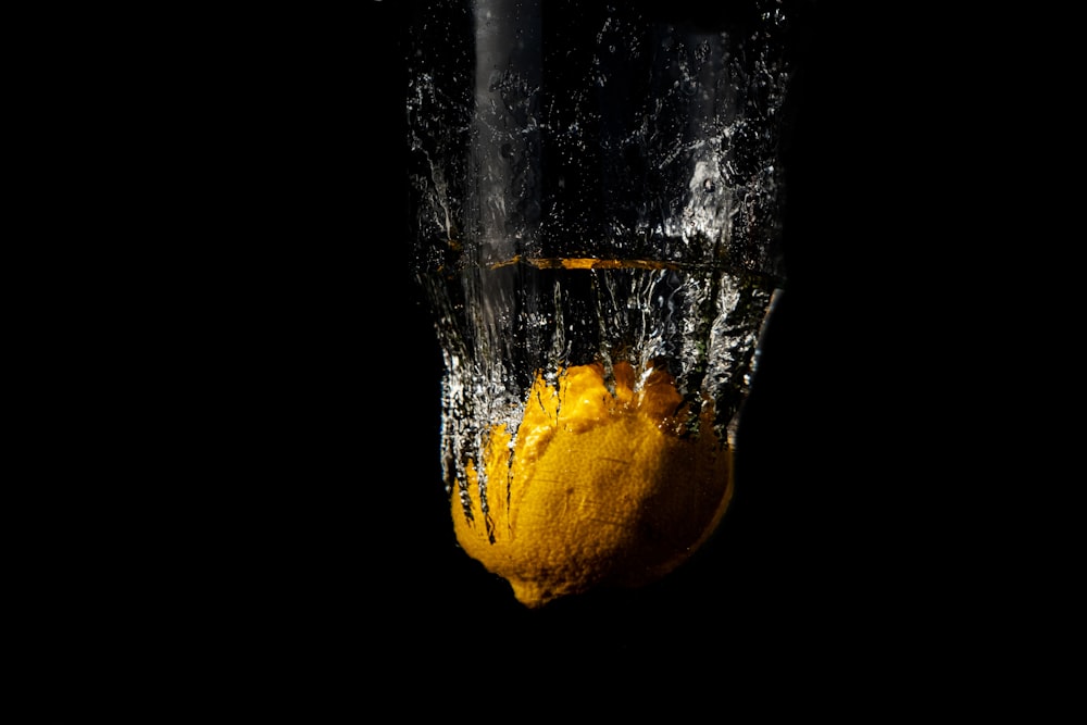 yellow lemon in clear drinking glass