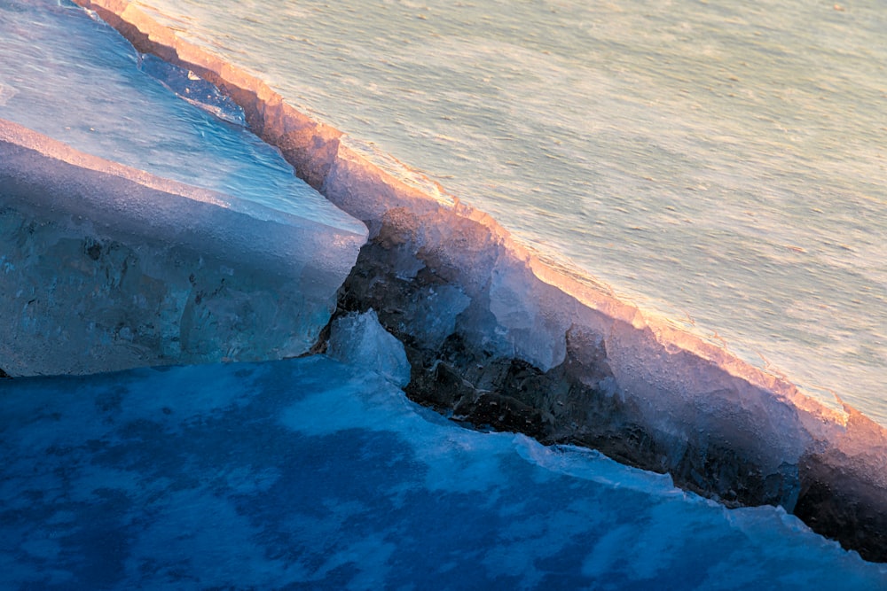 brown and white rock formation on body of water