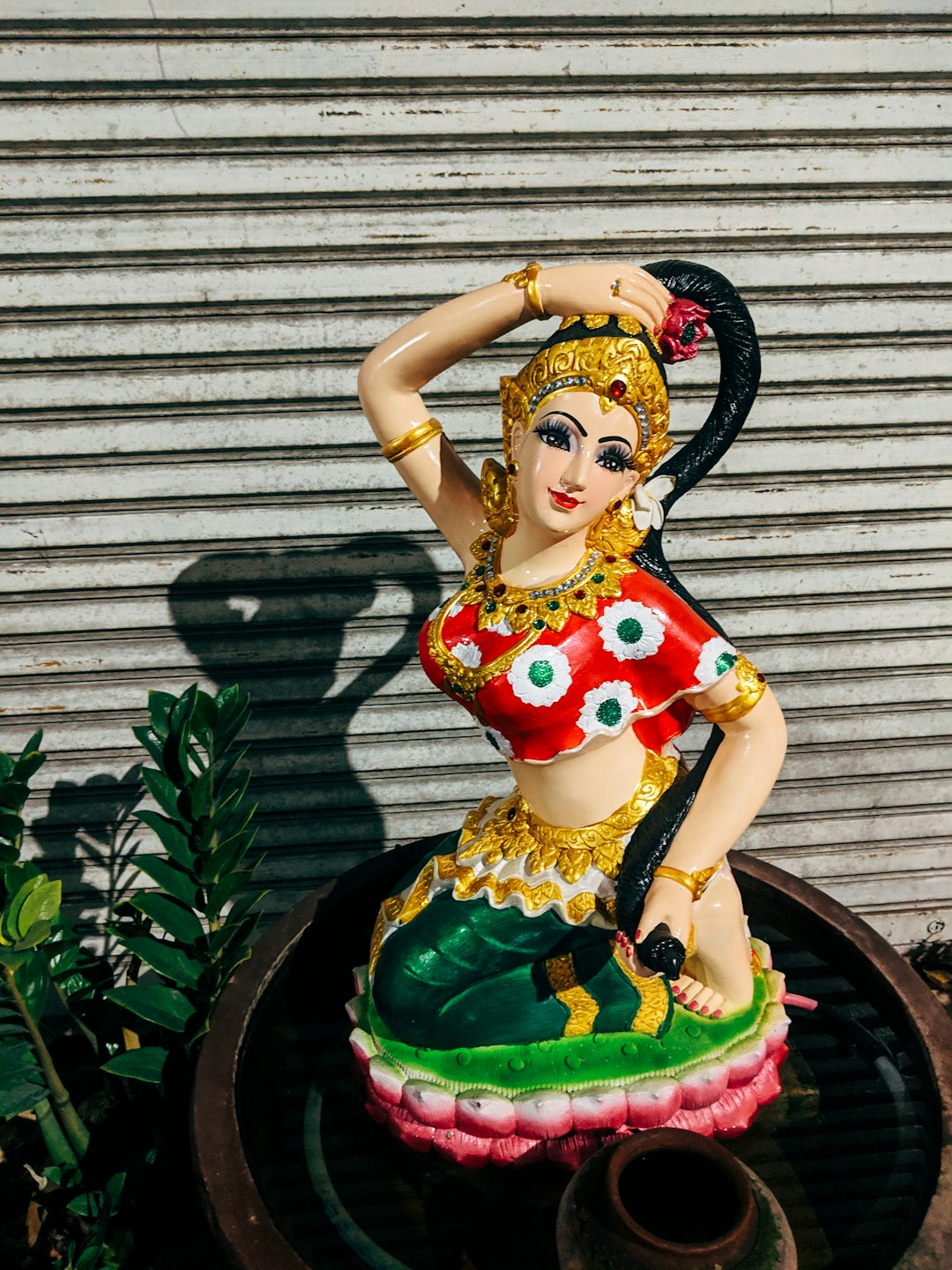 girl in yellow and red dress figurine