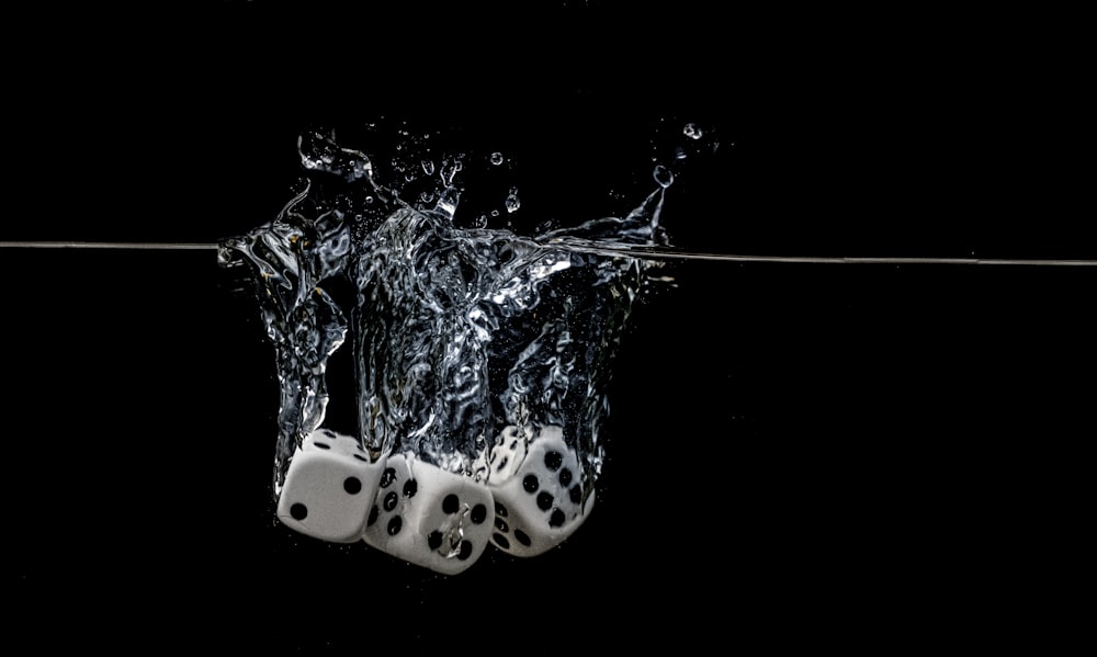 white and black polka dot ceramic mug with water