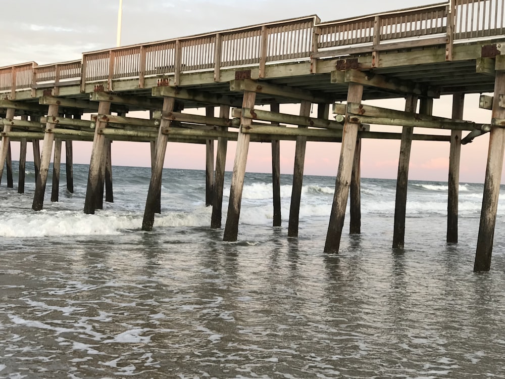 brown wooden dock on body of water during daytime