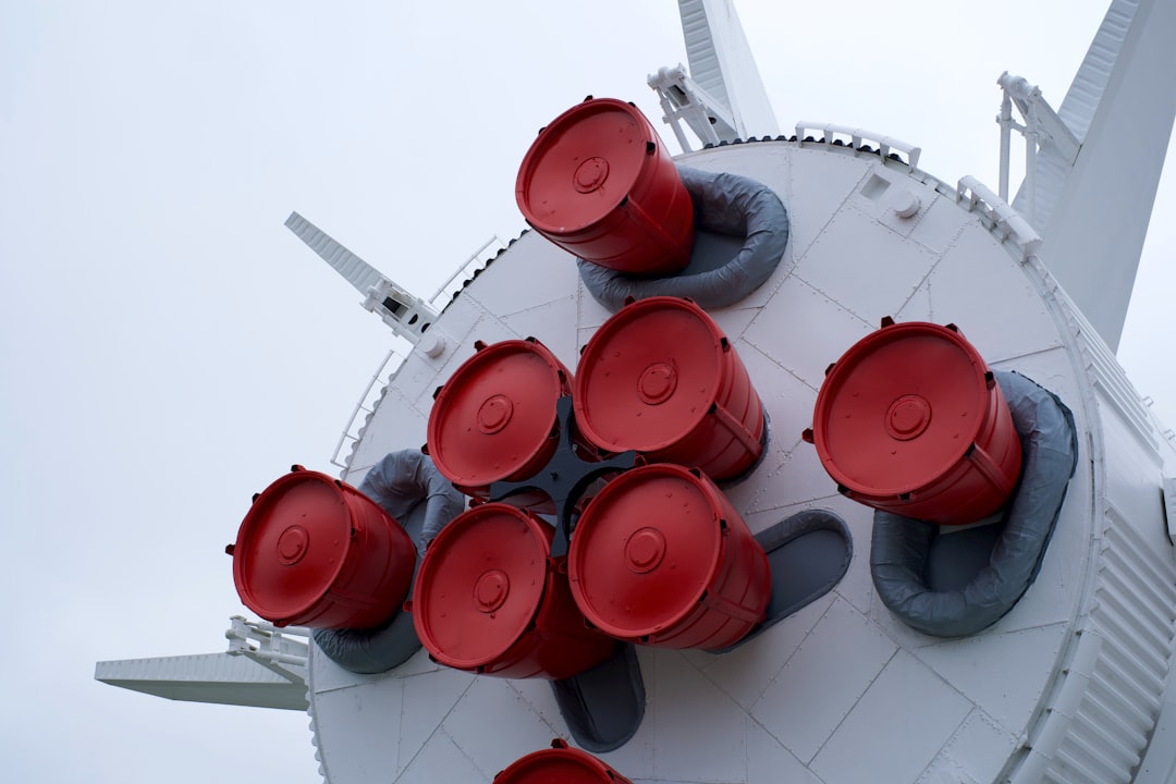 a group of red cups sitting on top of a white structure, In the Rocket Garden from a recent trip to Kennedy Space Center