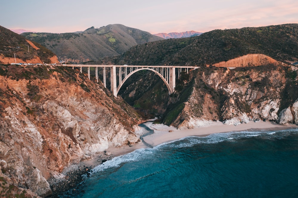 gray bridge over blue sea during daytime