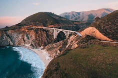 white bridge over the sea during daytime