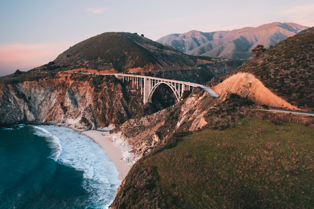 white bridge over the sea during daytime