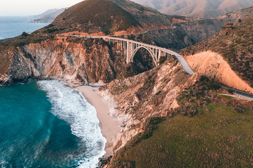 white bridge over the sea during daytime