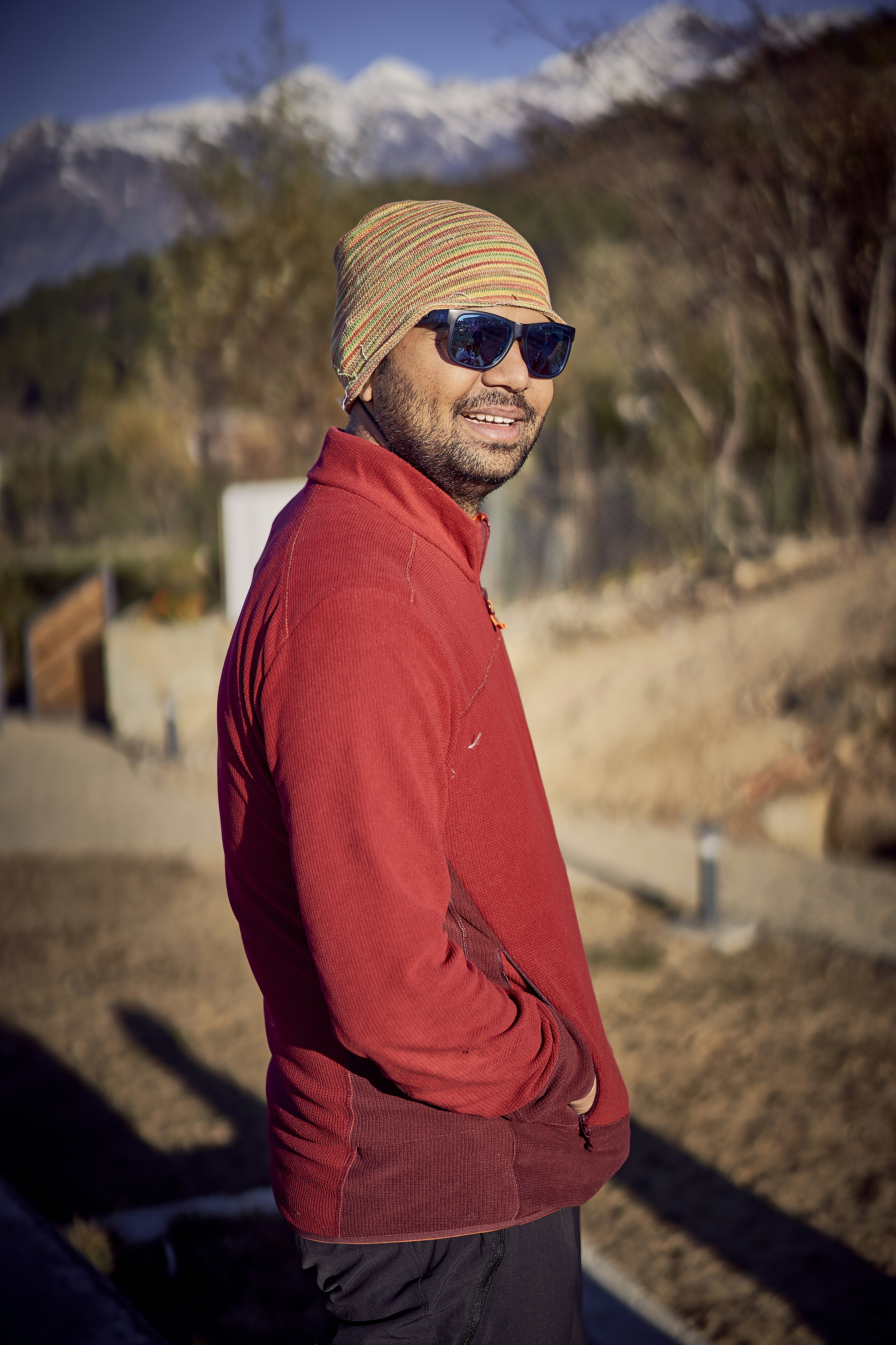 man in brown knit cap and orange sweater