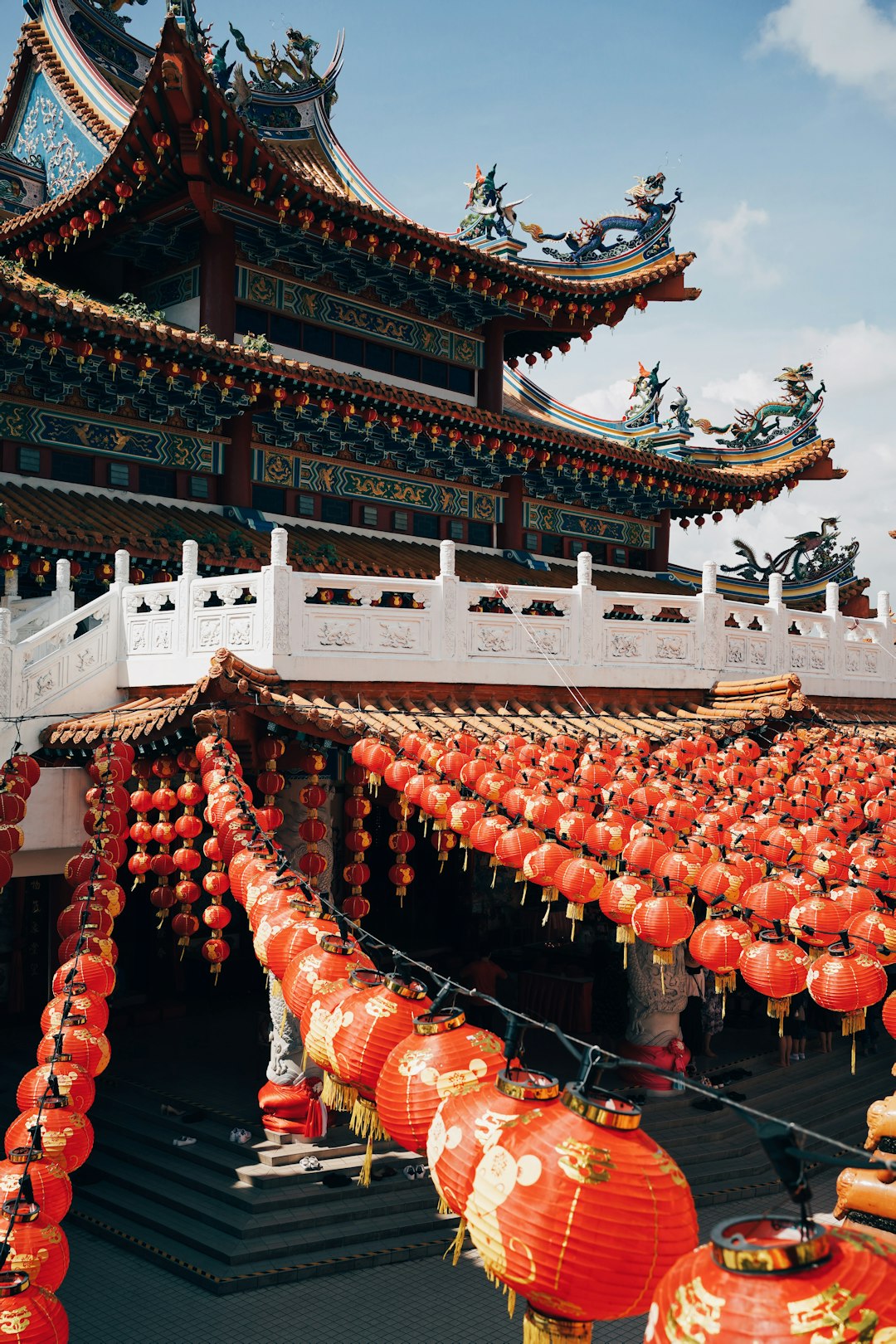 white and brown temple with orange chinese lanterns