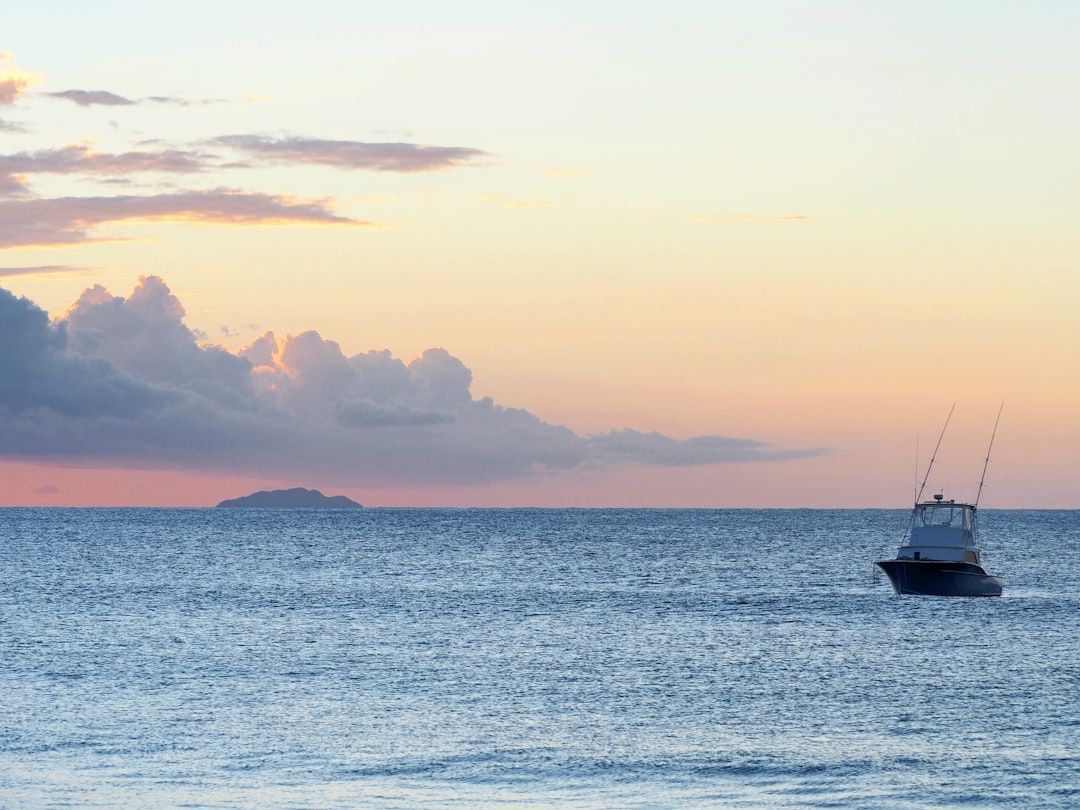 silhouette of boat on sea during sunset, Sunset at Aguadilla bay, Desecheo island in the back