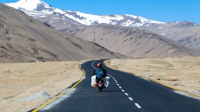 man riding motorcycle on road during daytime