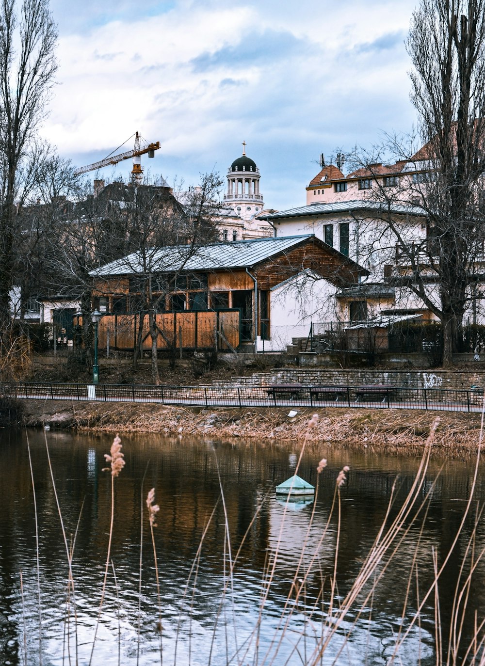 brown and white concrete building near body of water during daytime