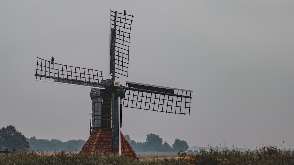 black and white windmill under gray sky