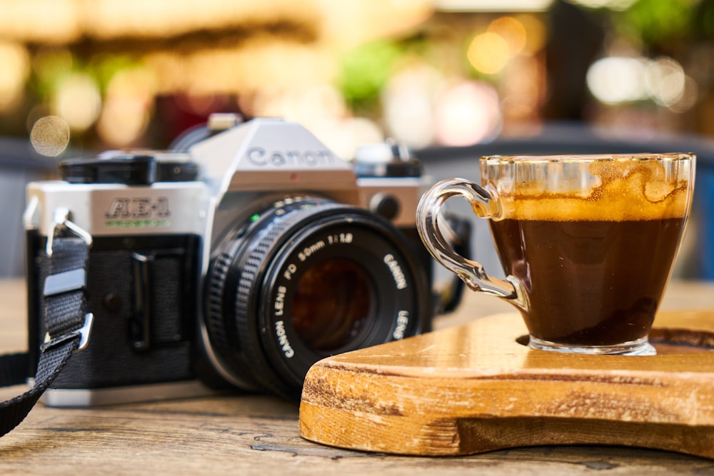 black and silver nikon dslr camera on brown wooden table