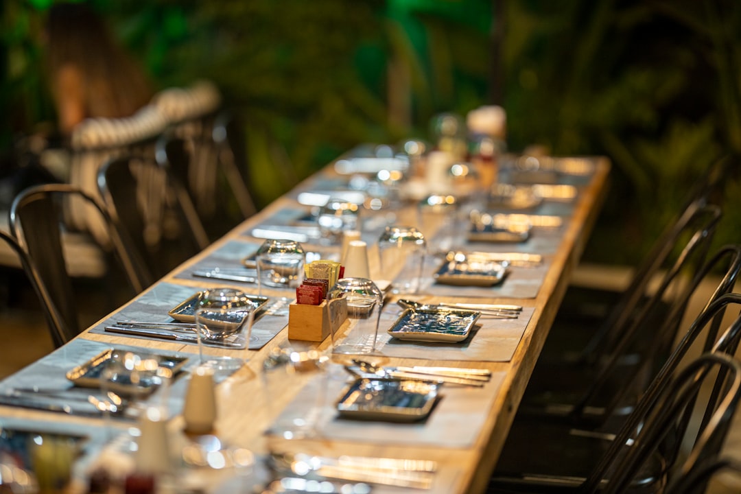 clear glass bottle on brown wooden table