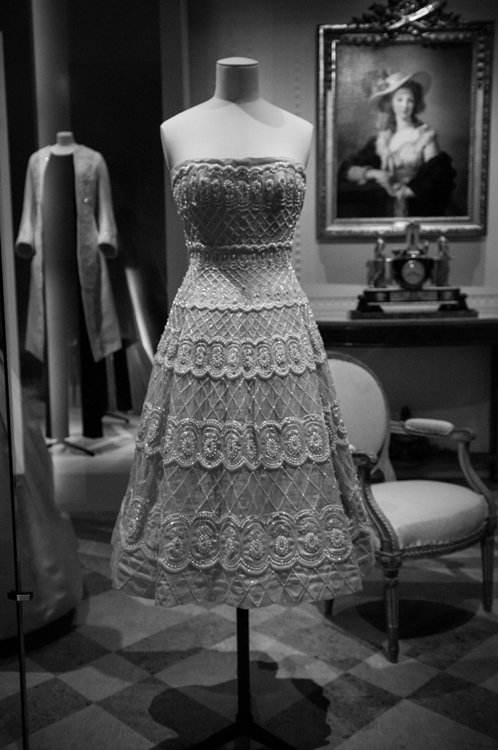 grayscale photo of a woman wearing floral dress