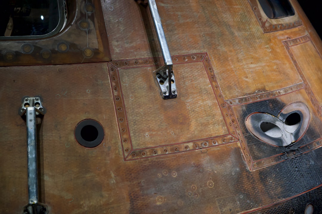 black and silver key on brown wooden table, Detail of the Apollo 14