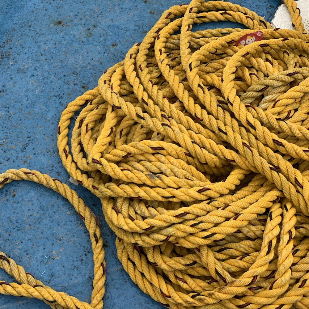 yellow rope on blue textile