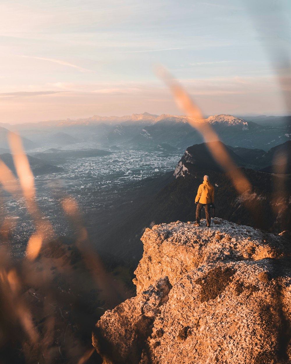 man standing on rock formation during daytime