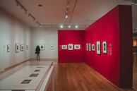 A spacious gallery corner featuring a large, framed modern artwork against a white wall.