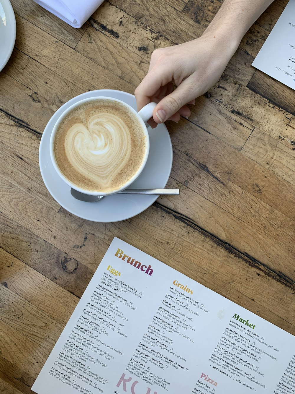 cappuccino on white ceramic cup on white ceramic saucer