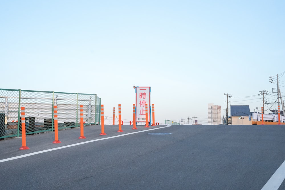 red and white metal fence near gray concrete road