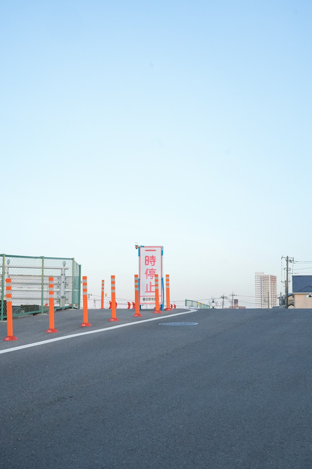 red and white metal fence near road during daytime