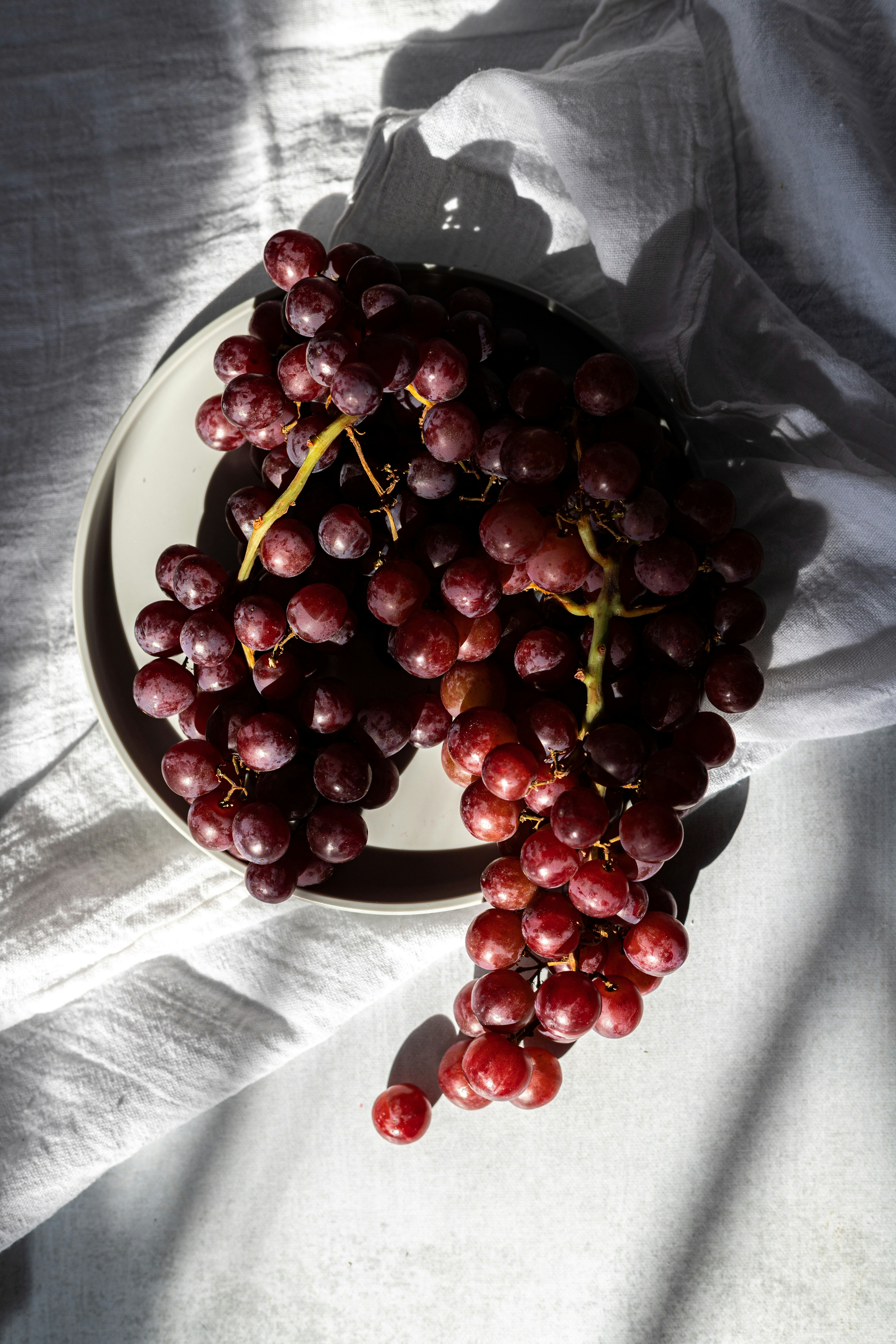 red cherries on white ceramic bowl