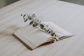 white floral on white book page