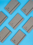 Several gray notebooks with elastic bands are arranged diagonally on a bright blue background. The word 'Swagup' is printed on each notebook.