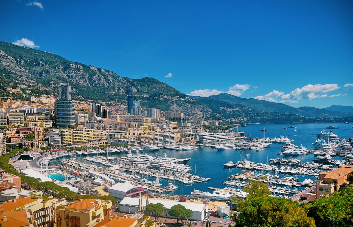 Yachts docked in the harbor of Monte Carlo with luxury buildings in the background