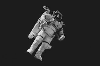 astronaut in white suit in grayscale photography