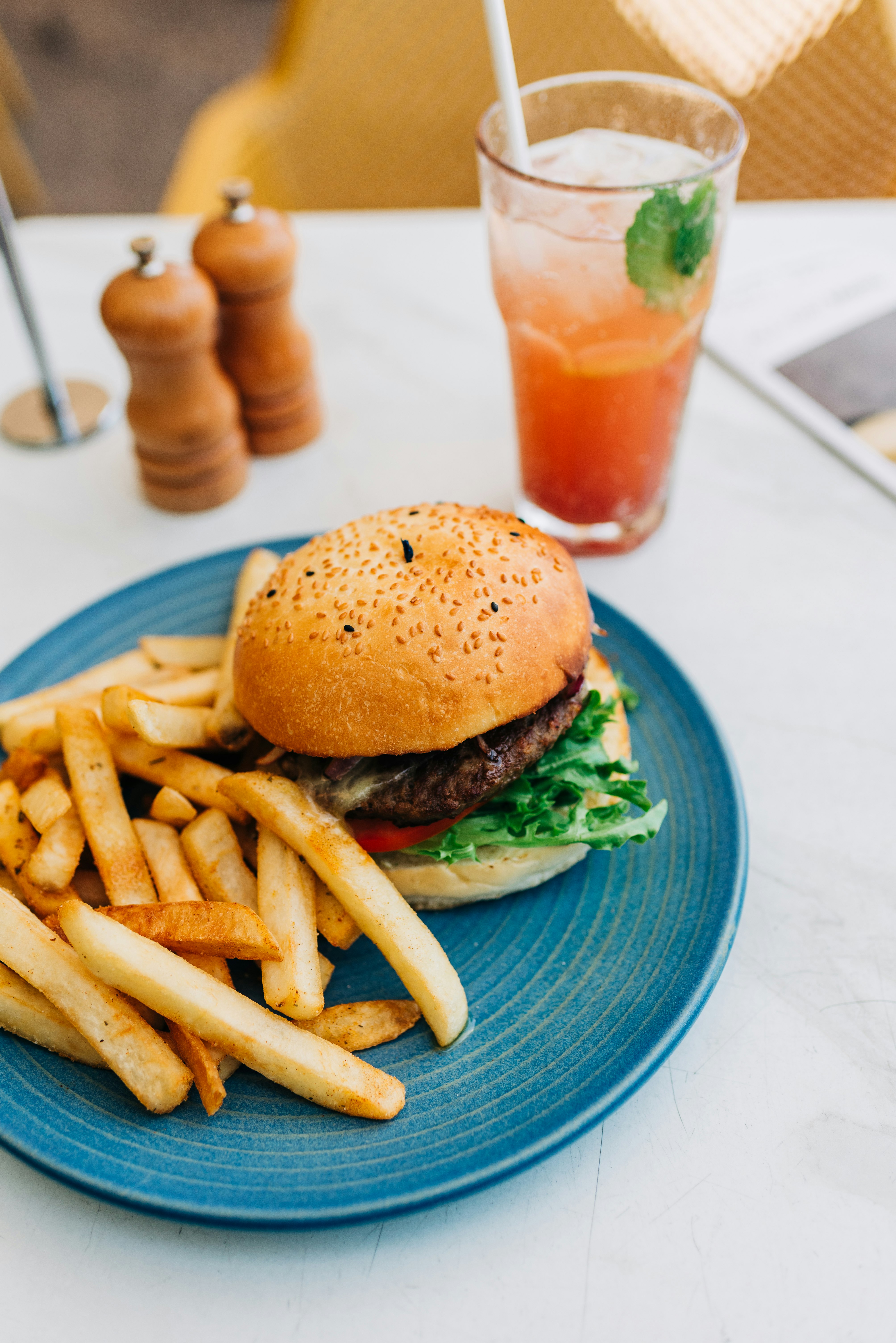 burger and fries on blue ceramic plate