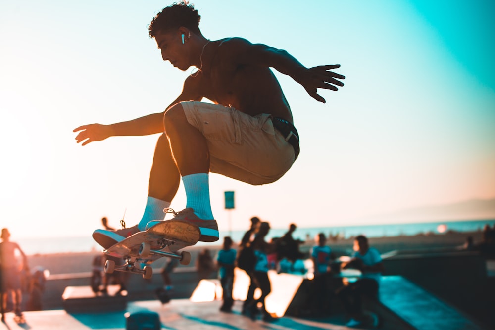 man in white shorts jumping on blue and white trampoline