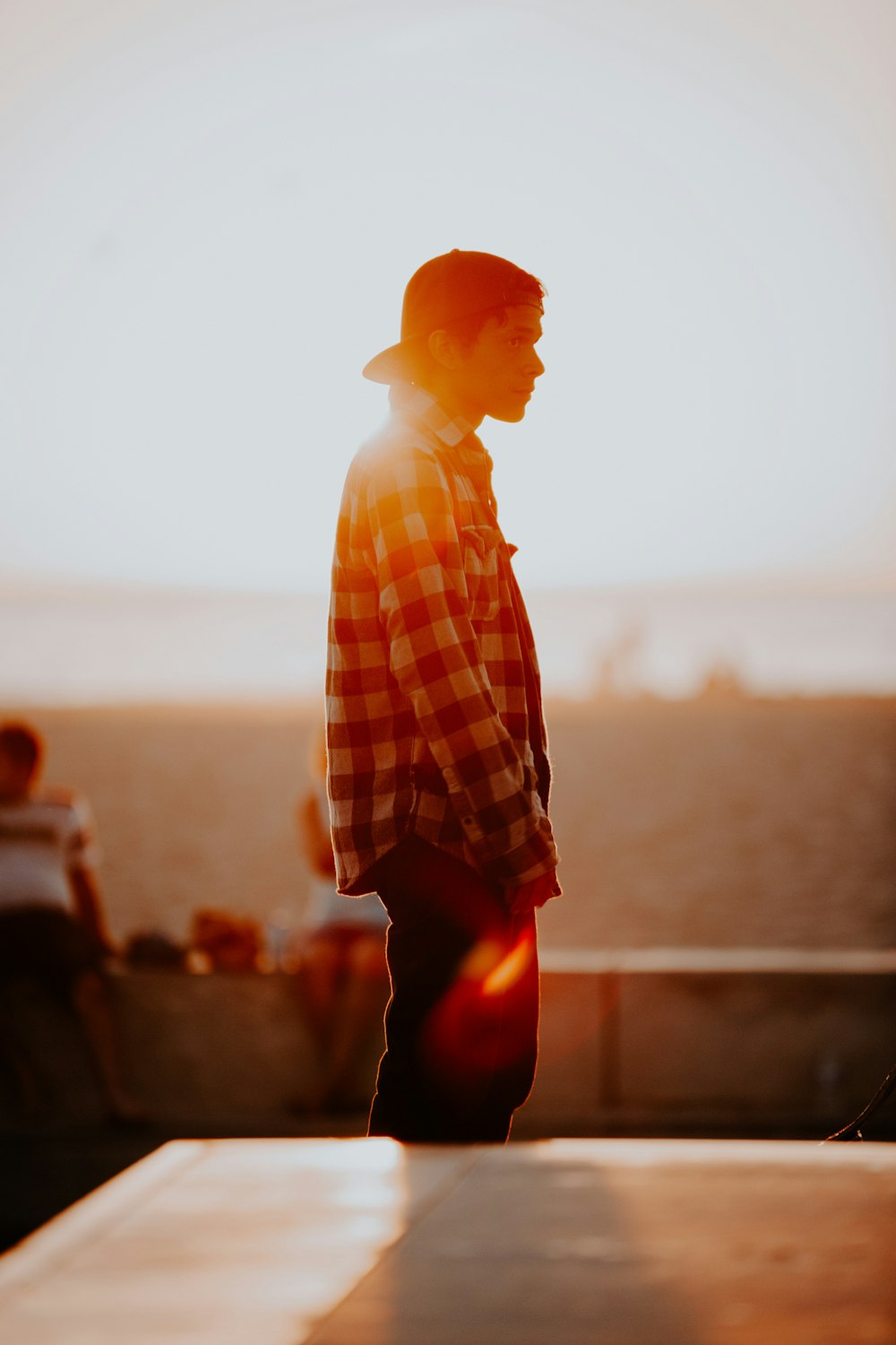 man in black and white plaid dress shirt standing during daytime