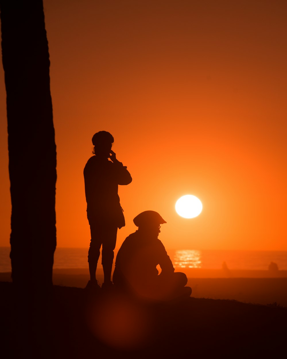 silhouette of man and woman kissing during sunset