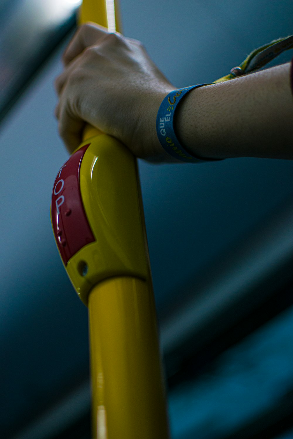 person holding yellow and red plastic toy