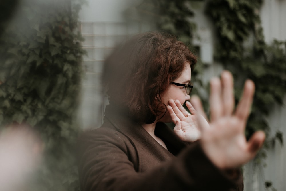 man in brown sweater wearing black framed eyeglasses