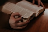 person holding white book page