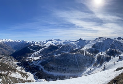 Snow-capped mountains towering above a peaceful alpine village bathed in morning light.