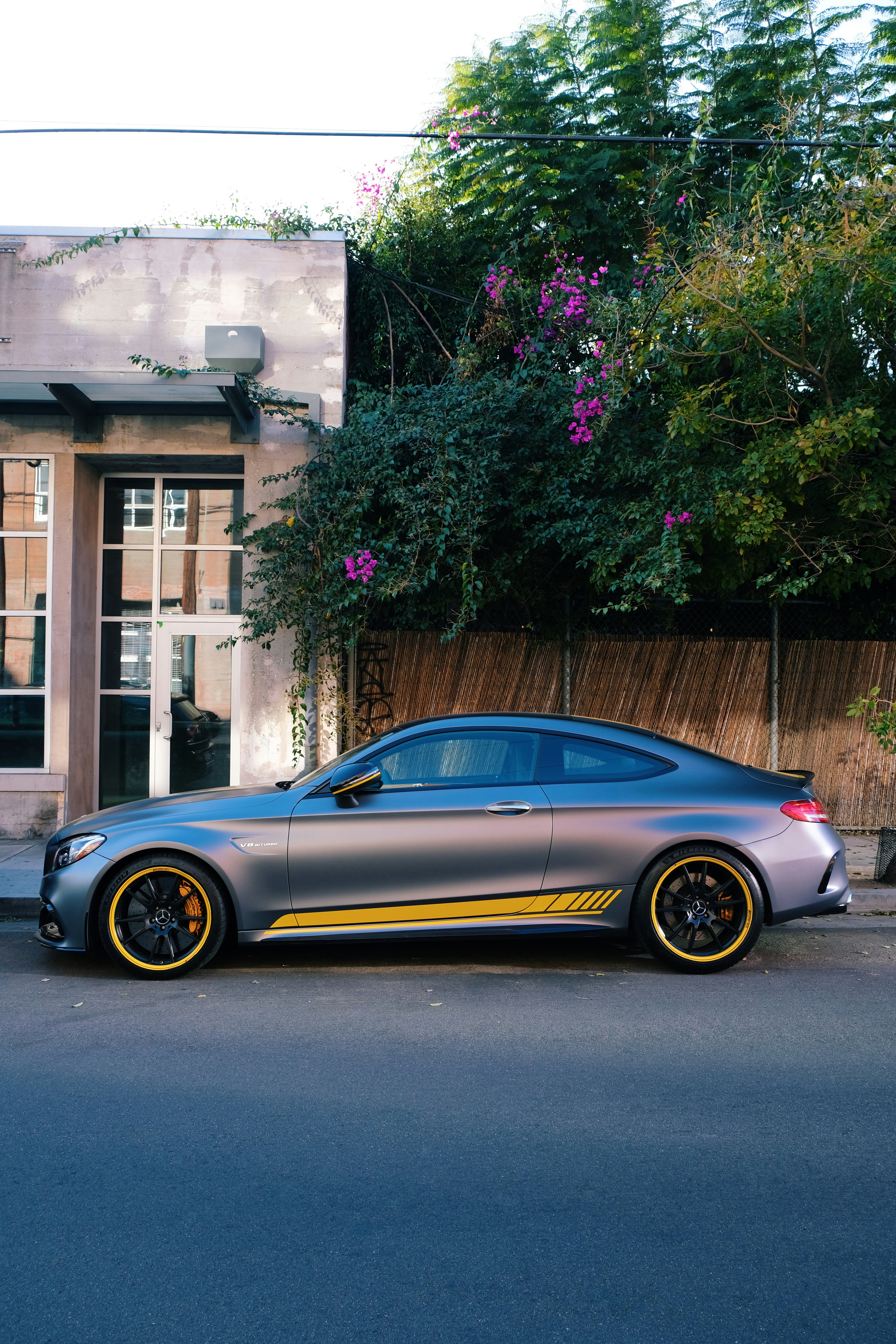 black porsche 911 parked near brown concrete building