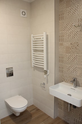 Completed bathroom renovation featuring modern tiles and updated plumbing.