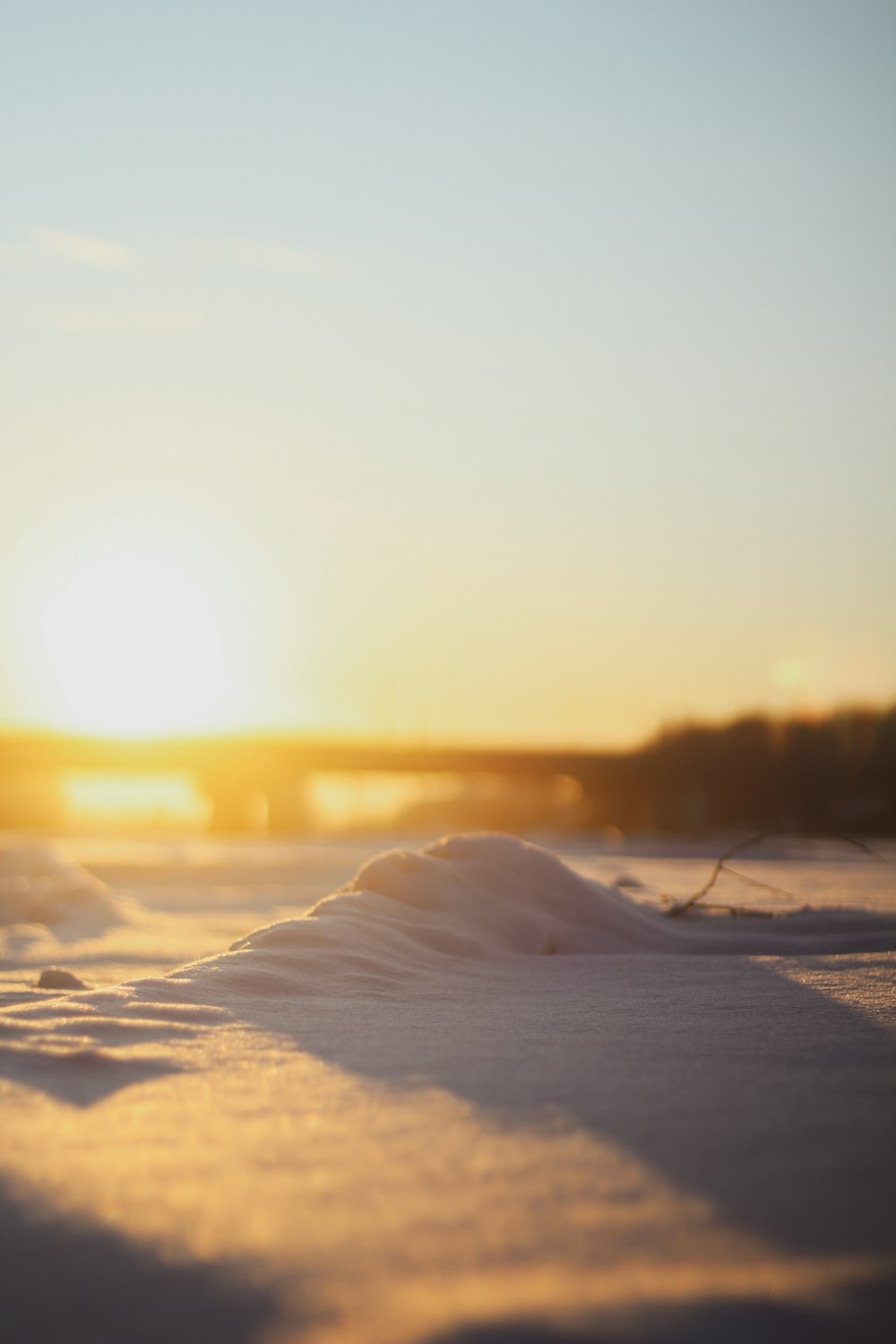 snow covered field during sunset