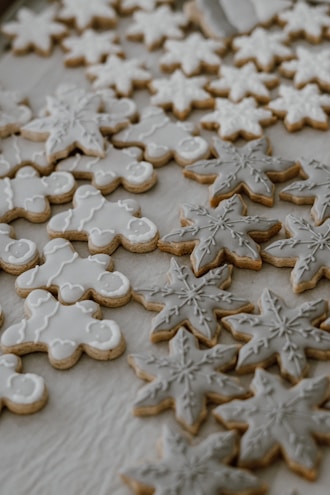 Colorful decorated cookies with intricate icing designs on a white plate.