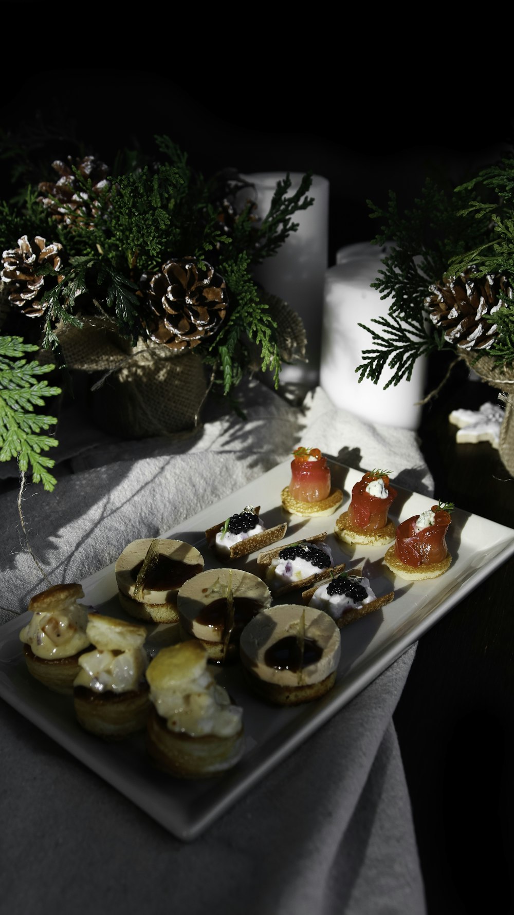 a plate of food on a table with pine cones