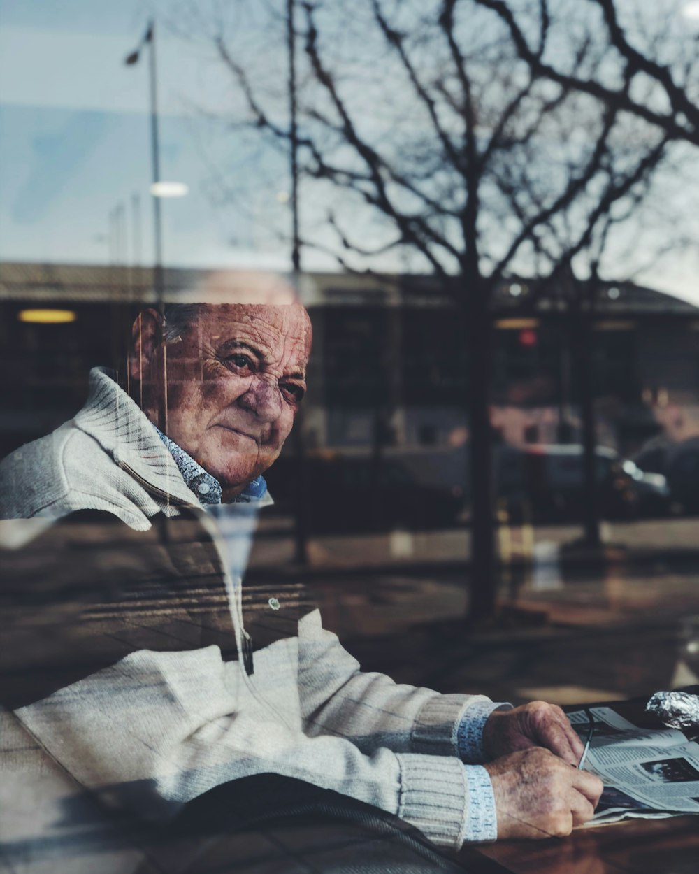 man in gray hoodie sitting on chair